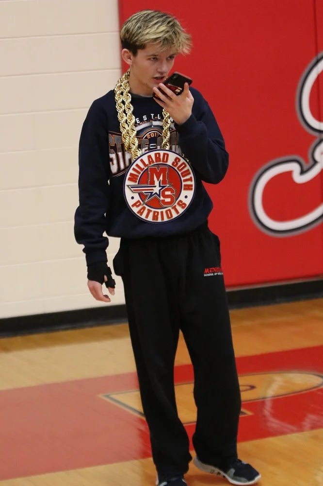 Basketball court wearing a navy blue sweatshirt with a large Chicago Bulls logo, a thick gold chain necklace