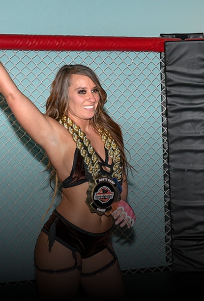 A woman posing inside a MMA cage